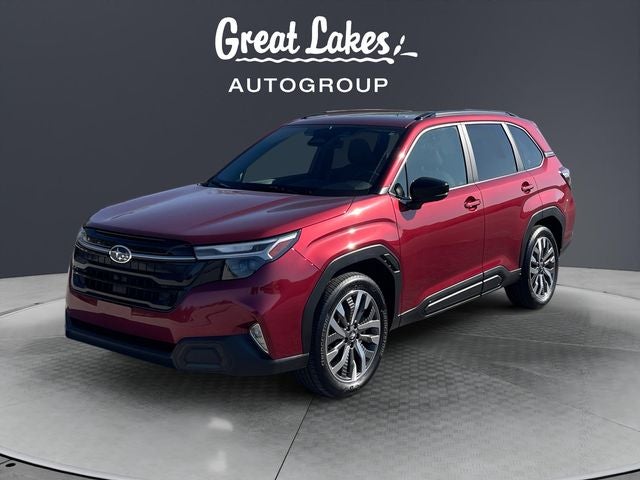 2025 Subaru Forester Touring in Crimson Red Pearl — front three-quarter view